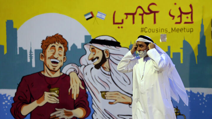 Ahmed Al Mansuri, founder of Crossroads of Civilization private museum, passes by a painting presenting UAE and Israel friendship at an exhibition commemorating the Jewish Holocaust in Dubai, United Arab Emirates, Wednesday, May 26, 2021.